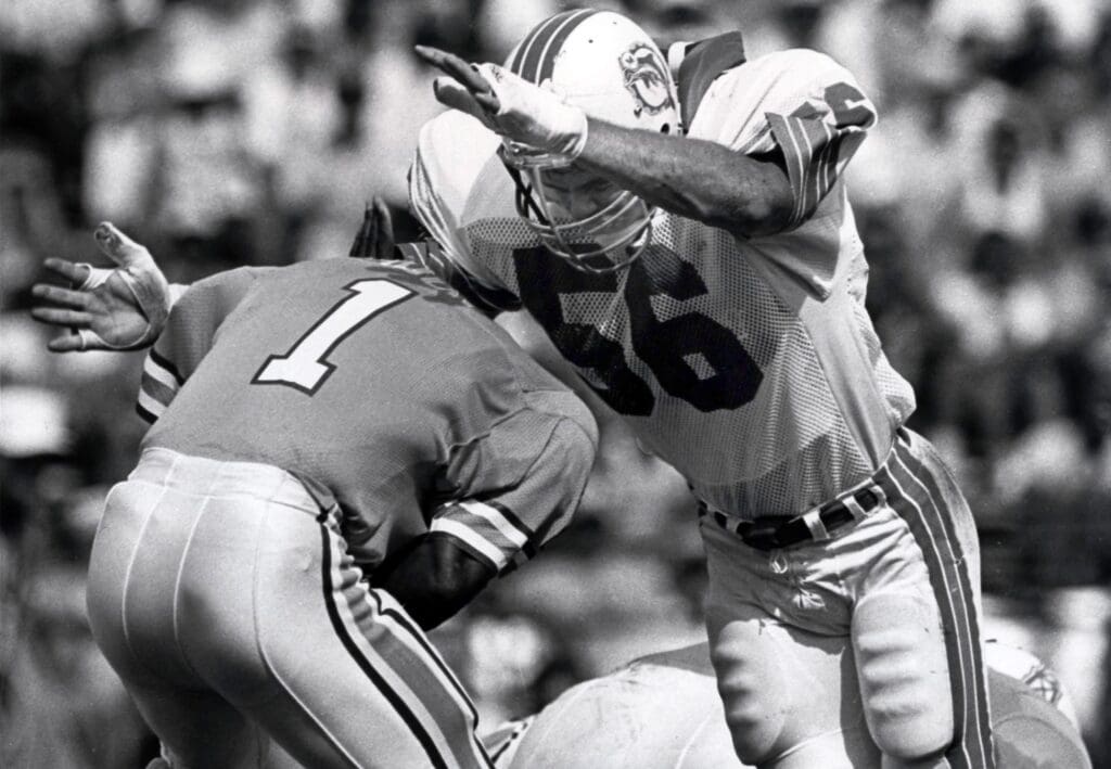 Nov 2, 1986, Miami, FL, USA; FILE PHOTO; Miami Dolphins linebacker John Offerdahl (56) sacks Houston Oilers quarterback Warren Moon (1) during the 1986 season at the Orange Bowl.