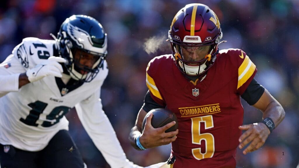 Dec 22, 2024; Landover, Maryland, USA; Washington Commanders quarterback Jayden Daniels (5) runs the ball against Philadelphia Eagles linebacker Josh Sweat (19) during the second quarter at Northwest Stadium.