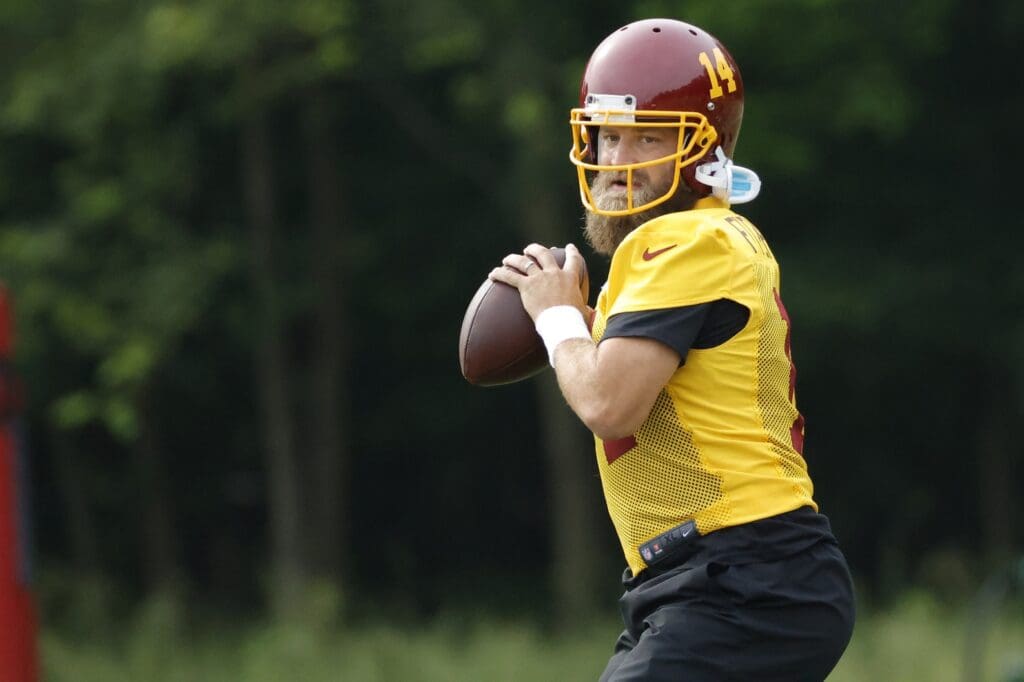 Jun 2, 2021; Ashburn, VA, USA; Washington Football Team quarterback Ryan Fitzpatrick (14) prepares to pass the ball during drills as part of an OTA at Inova Sports Performance Center. 