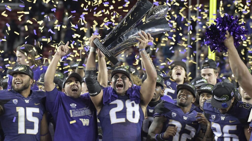 Dec 2, 2016; Santa Clara, CA, USA; Washington Huskies players celebrate with the championship trophy after the Pac-12 championship against the Colorado Buffaloes at Levi's Stadium. Washington defeated Colorado 41-10.