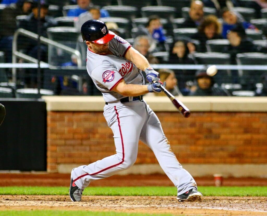 Oct 3, 2015; New York City, NY, USA; Washington Nationals second baseman Dan Uggla (26) hits a solo home run against the New York Mets in the seventh inning during game two at Citi Field. The Nationals defeated the Mets 2-0.