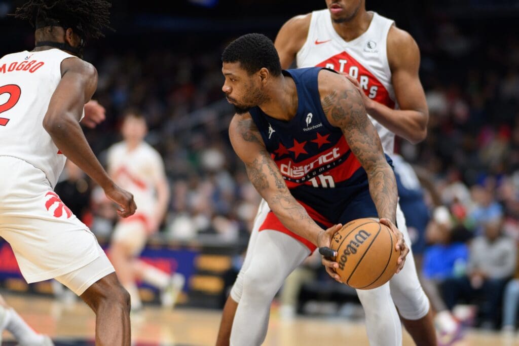 Mar 24, 2025; Washington, District of Columbia, USA; Washington Wizards guard Marcus Smart (36) rebounds the ball during the third quarter against Toronto Raptors forward Jonathan Mogbo (2) at Capital One Arena.