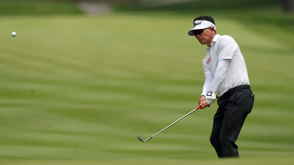 Y.E. Yang watches his shot onto the green on the fourth hole during the final round of the Kaulig Companies Championship golf tournament at Firestone Country Club, Sunday, July 14, 2024, in Akron, Ohio.