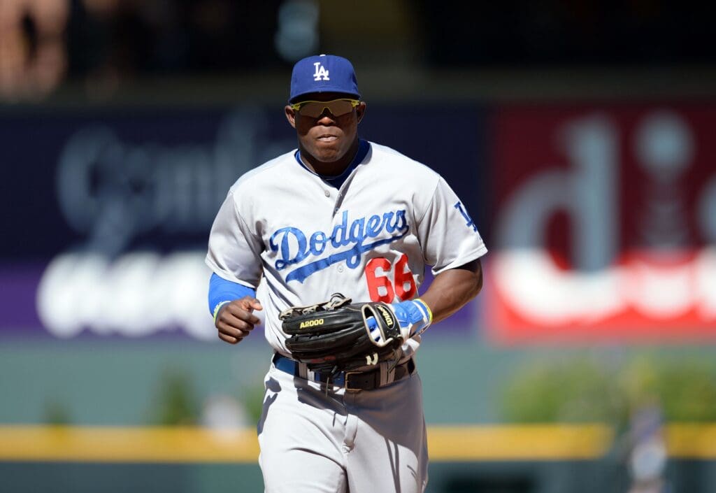 Sep 17, 2014; Denver, CO, USA; Los Angeles Dodgers right fielder Yasiel Puig (66) runs back to the dugout in the fourth inning against the Colorado Rockies at Coors Field.