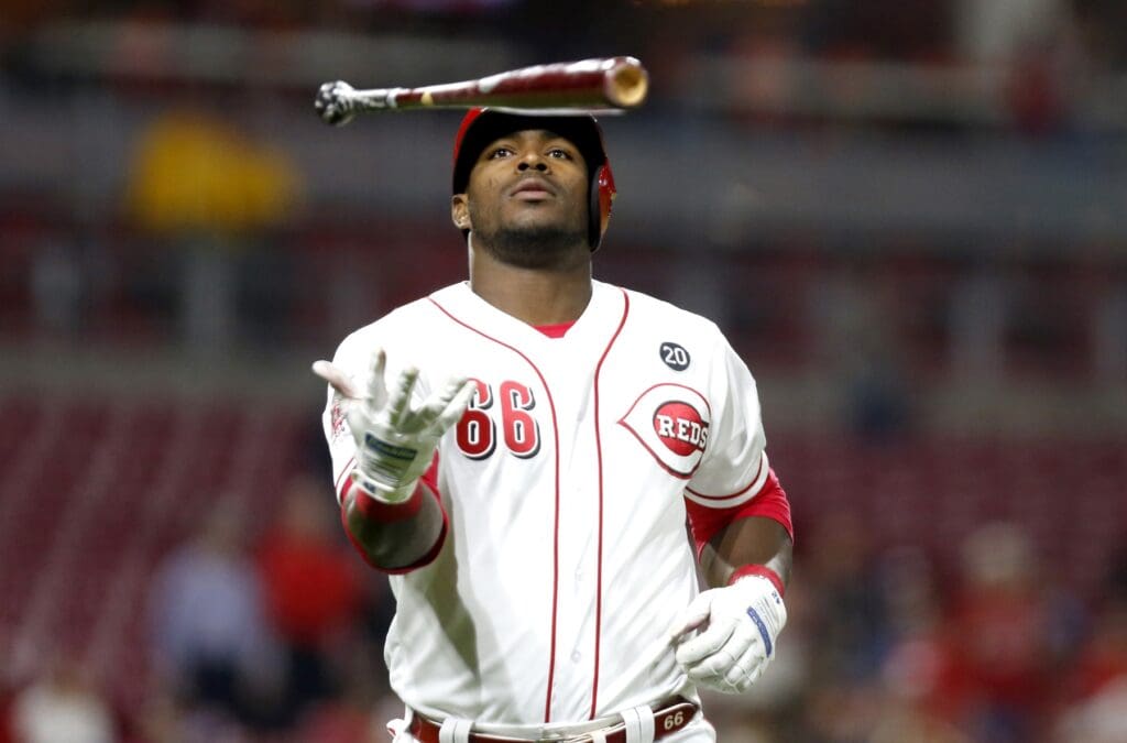 Apr 23, 2019; Cincinnati, OH, USA; Cincinnati Reds right fielder Yasiel Puig (66) throws his bat after hitting a sacrifice fly against the Atlanta Braves during the sixth inning at Great American Ball Park