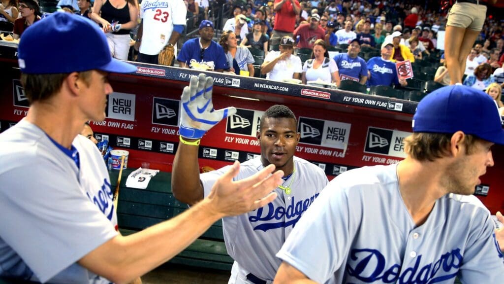 Apr 13, 2014; Phoenix, AZ, USA; Los Angeles Dodgers outfielder Yasiel Puig (center) greets Zack Greinke (left) against the Arizona Diamondbacks at Chase Field.