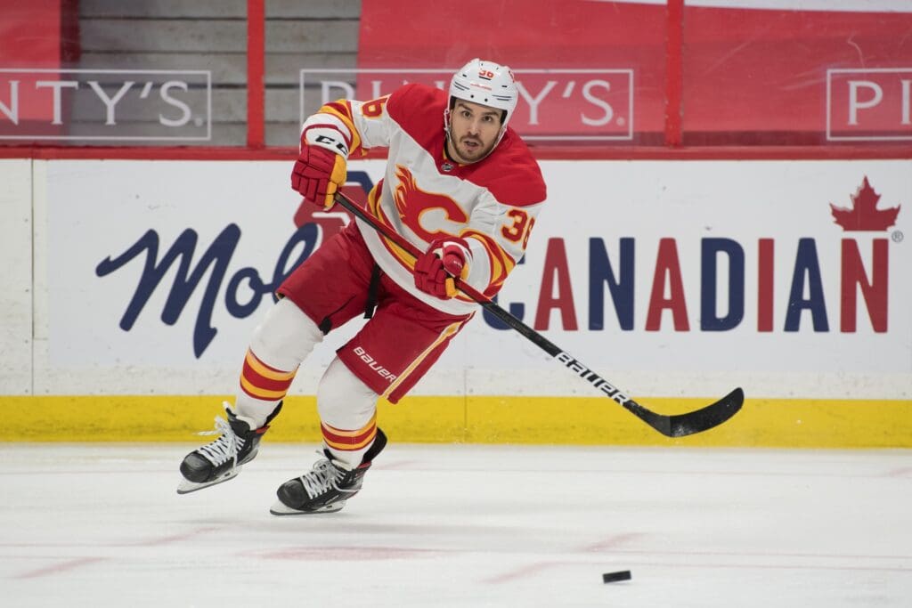 Mar 24, 2021; Ottawa, Ontario, CAN; Calgary Flames center Zac Rinaldo (36) moves the puck during the second period against the Ottawa Senators at the Canadian Tire Centre.