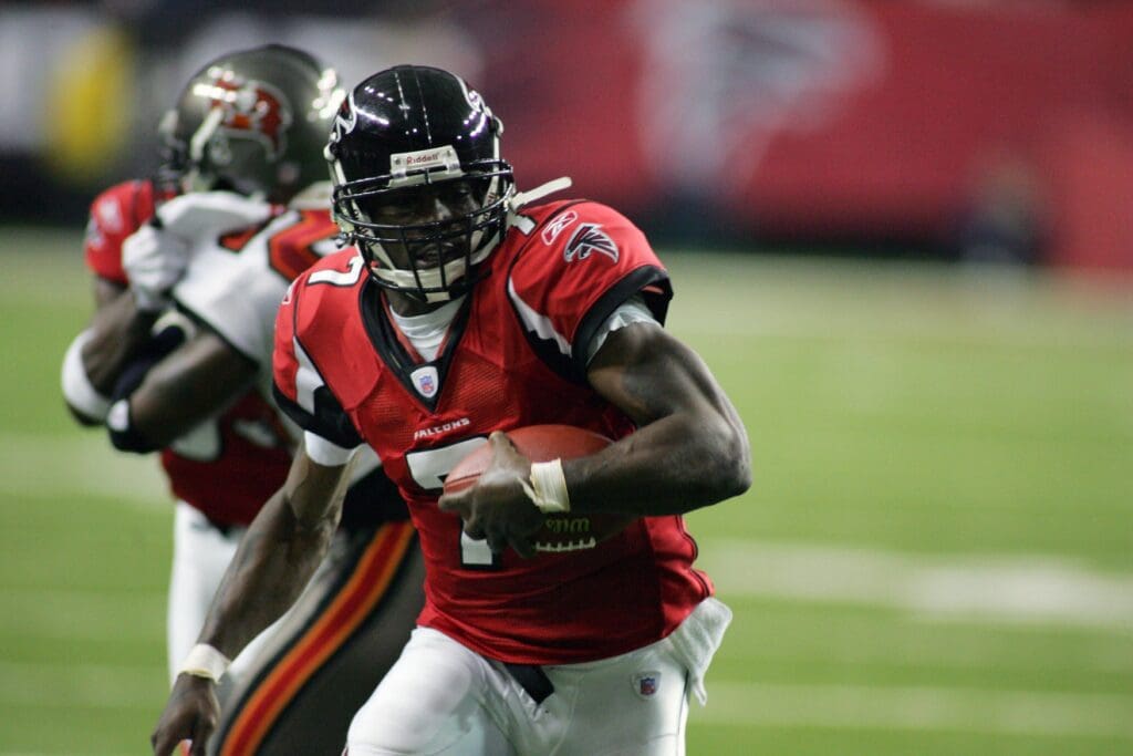 Nov 20, 2005; Atlanta, GA, USA; Atlanta Falcons quarterback (7) Michael Vick finds a seam against the Tampa Bay Buccaneers defense in action at the Georgia Dome. The Buccaneers won 30-27.