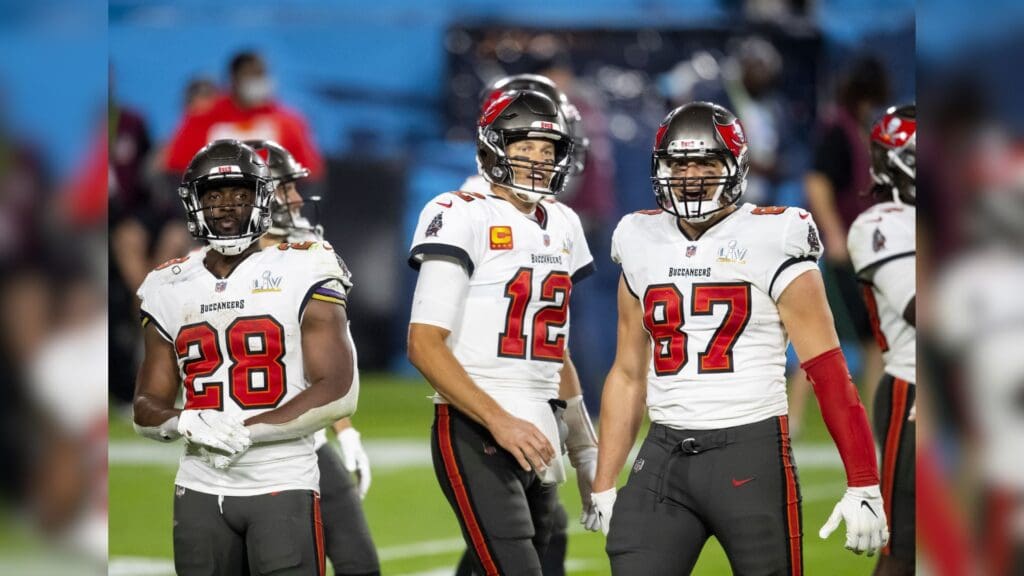 Feb 4, 2020; Tampa, FL, USA; Tampa Bay Buccaneers running back Leonard Fournette (28) with quarterback Tom Brady (12) and tight end Rob Gronkowski (87) against the Kansas City Chiefs in Super Bowl LV at Raymond James Stadium.