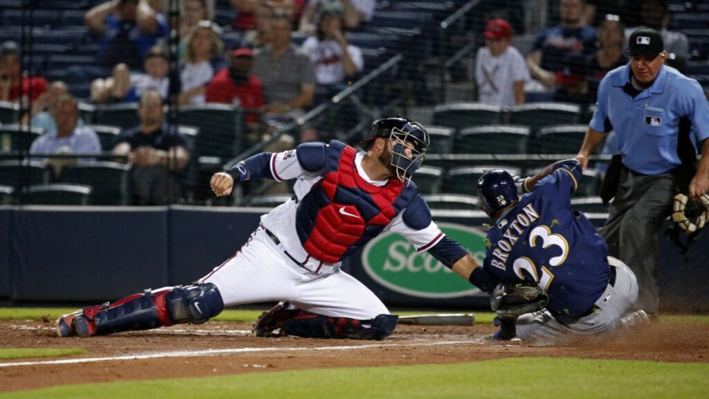 May 25, 2016; Atlanta, GA, USA; Atlanta Braves catcher A.J. Pierzynski (15) tags out Milwaukee Brewers center fielder Keon Broxton (23) in the 13th inning of their game at Turner Field. The Brewers won 3-2 in 13 innings.