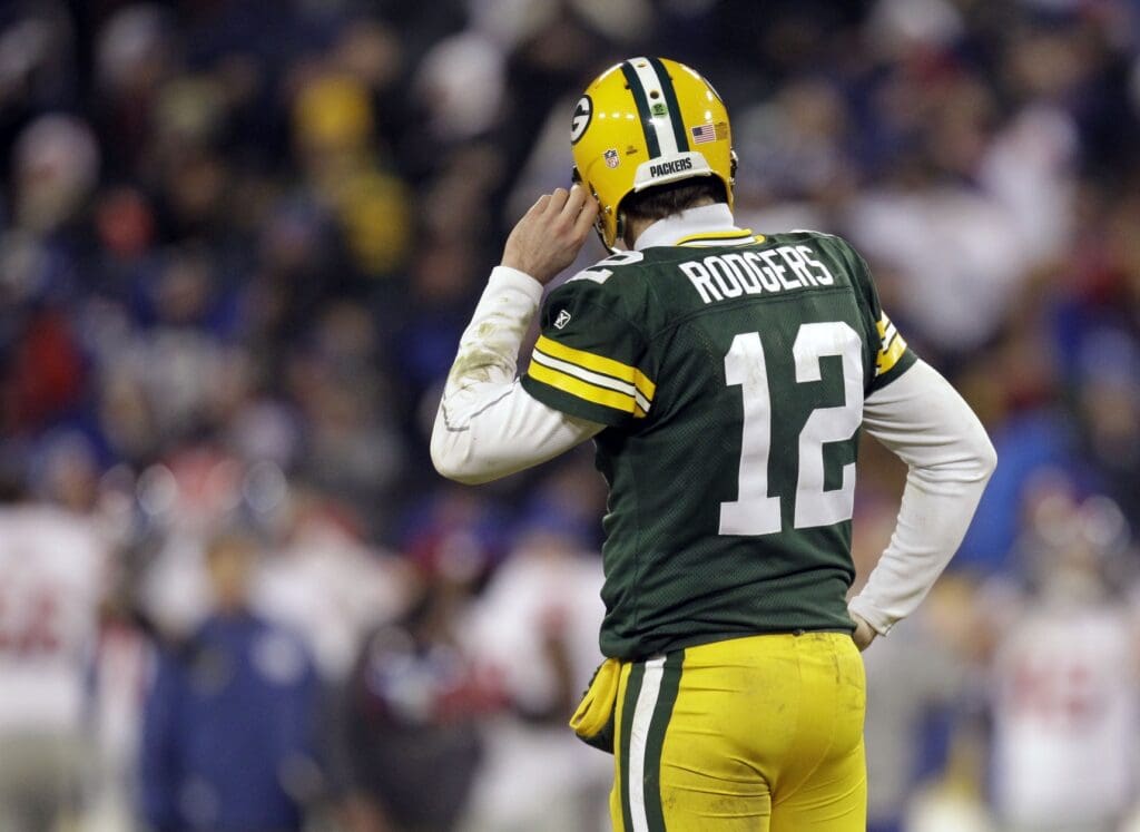 Jan 15, 2012; Green Bay, WI, USA; Green Bay Packers quarterback Aaron Rodgers (12) reacts in the second half of the 2011 NFC divisional playoff game against the New York Giants at Lambeau Field. The Giants won 37-20.