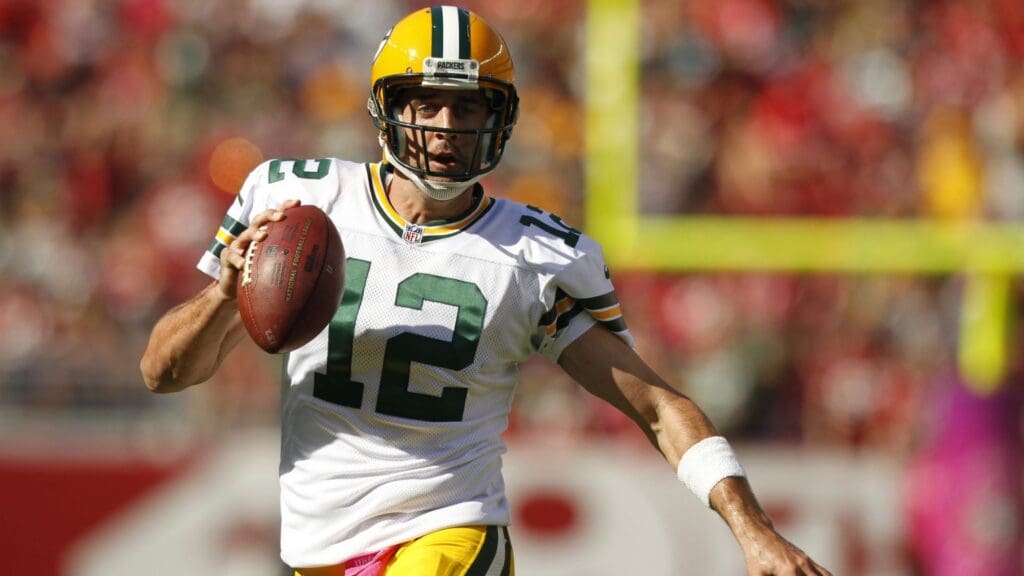 Oct 4, 2015; Santa Clara, CA, USA; Green Bay Packers quarterback Aaron Rodgers (12) runs for a first down against the San Francisco 49ers in the third quarter at Levi's Stadium. The Packers defeated the 49ers 17-3.