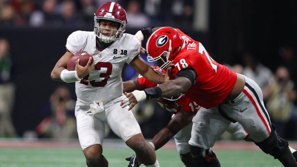 Jan 8, 2018; Atlanta, GA, USA; Alabama Crimson Tide quarterback Tua Tagovailoa (13) runs with the ball during the second half against Georgia Bulldogs defensive tackle Trenton Thompson (78) and linebacker D'Andre Walker (15) in the 2018 CFP national championship college football game at Mercedes-Benz Stadium. 