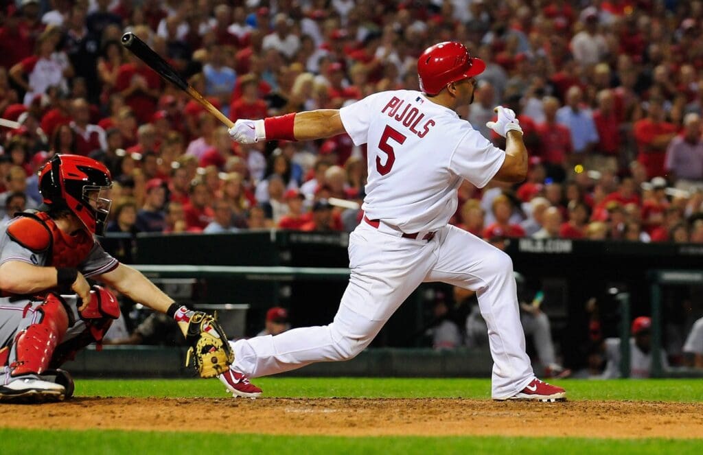 July 6, 2011; St. Louis, MO. USA; St. Louis Cardinals first baseman Albert Pujols (5) follows through on a one run single against the Cincinnati Reds at Busch Stadium. Cincinnati defeated St. Louis 9-8 in 13 innings.