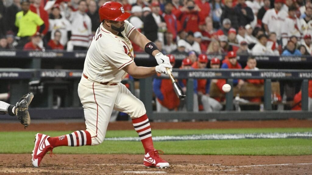 Oct 8, 2022; St. Louis, Missouri, USA; St. Louis Cardinals designated hitter Albert Pujols (5) hits a single in the sixth inning against the Philadelphia Phillies during game two of the Wild Card series for the 2022 MLB Playoffs at Busch Stadium.
