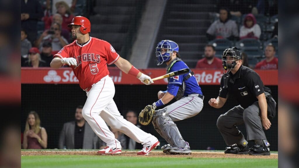 Apr 11, 2017; Anaheim, CA, USA; Los Angeles Angels designated hitter Albert Pujols (5) follows through on a run-scoring single in the ninth inning against the Texas Rangers at Angel Stadium of Anaheim. The Angels defeated the Rangers 6-5 in 10 innings. 