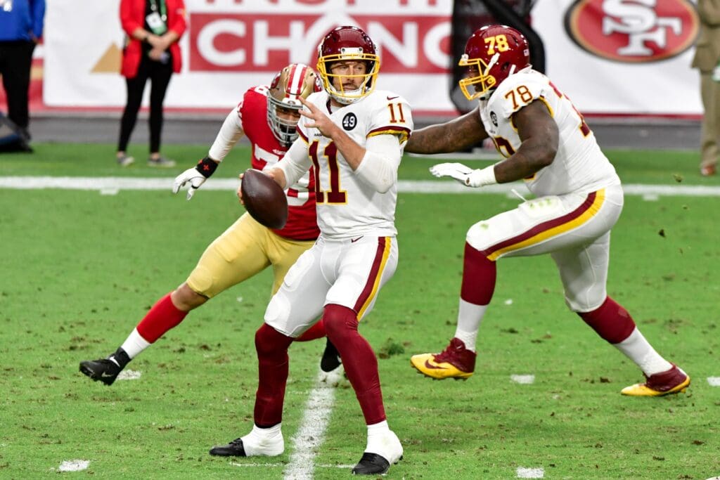 Dec 13, 2020; Glendale, Arizona, USA; Washington Football Team quarterback Alex Smith (11) looks to pass during the first half against the San Francisco 49ers at State Farm Stadium.