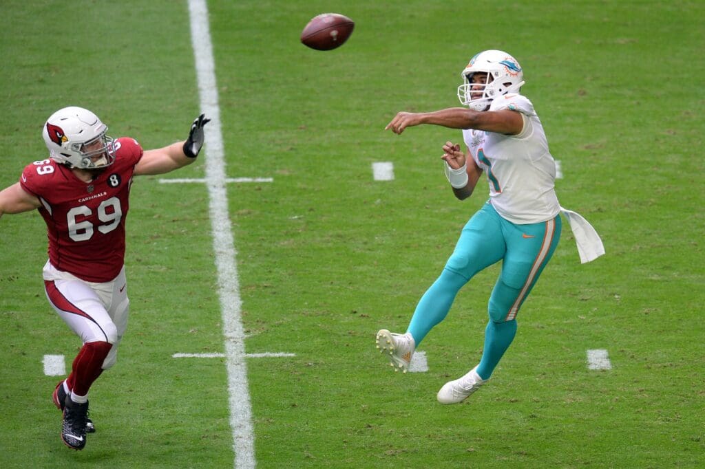 Nov 8, 2020; Glendale, Arizona, USA; Miami Dolphins quarterback Tua Tagovailoa (1) passes the ball by Arizona Cardinals defensive lineman Josh Mauro (69) during the first half at State Farm Stadium. M