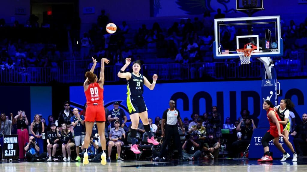 Jul 30, 2025; Arlington, Texas, USA; Atlanta Dream forward Naz Hillmon (00) hits the game-winning shot over Dallas Wings center Li Yueru (28) during the second half at College Park Center.