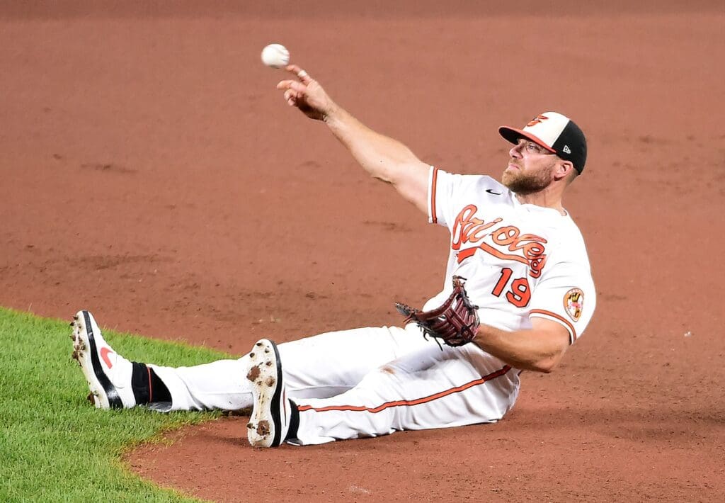 Aug 18, 2020; Baltimore, Maryland, USA; Baltimore Orioles first baseman Chris Davis (19) throws the ball to home plate in the tenth inning against the Toronto Blue Jays at Oriole Park at Camden Yards.