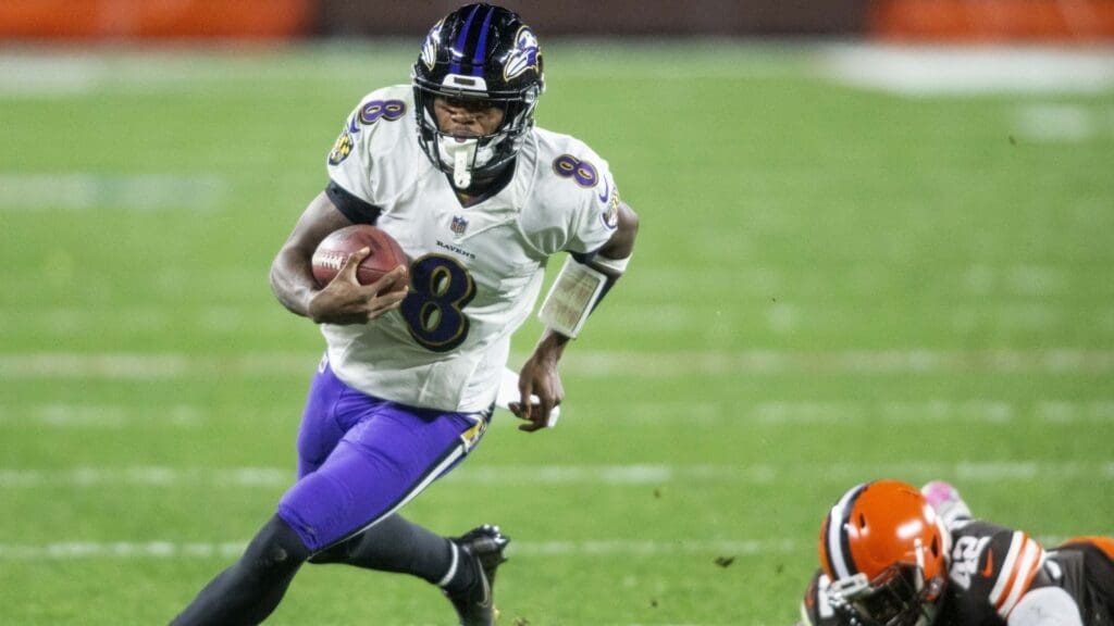 Dec 14, 2020; Cleveland, Ohio, USA; Baltimore Ravens quarterback Lamar Jackson (8) runs the ball past Cleveland Browns strong safety Karl Joseph (42) during the second quarter at FirstEnergy Stadium. 
