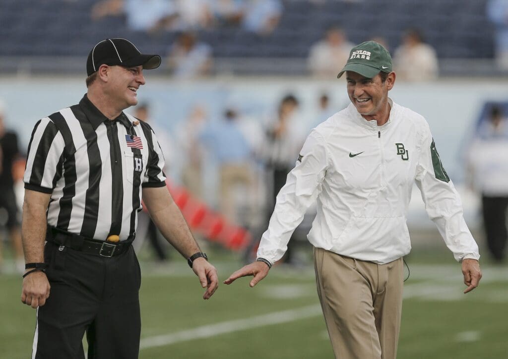 Dec 29, 2015; Orlando, FL, USA; Baylor Bears head coach Art Briles (right) meets with an official during pre game warmups before the Russell Athletic Bowl against the North Carolina Tar Heels at the Florida Citrus Bowl.