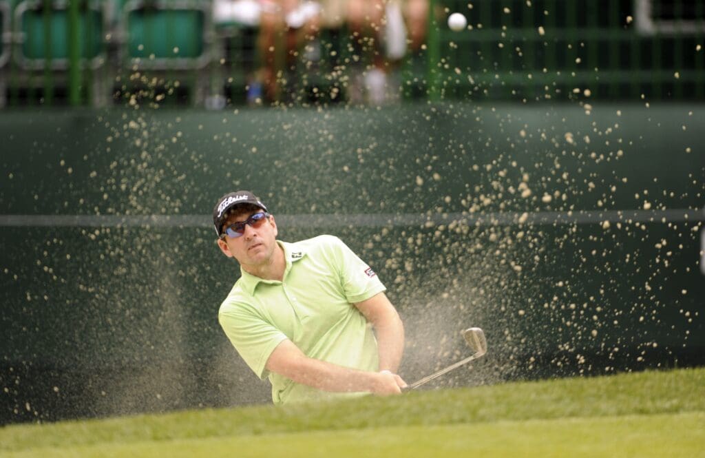 Apr 22, 2011; Hilton Head, SC, USA; Ben Curtis blasts out of the bunker onto the 15th green during the second round of the Heritage Classic at the Harbour Town Golf Links.