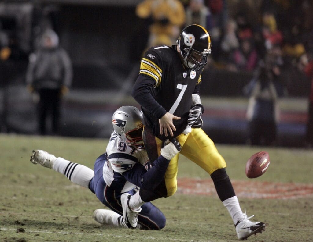 Jan 23, 2005; Pittsburgh, PA, USA; FILE PHOTO; Pittsburgh Steelers quarterback #7 Ben Roethlisberger fumbles the ball after being hit by New England Patriots defensive lineman #97 Jarvis Green during the 2nd quarter of the 2004 AFC Championship game at Heinz Field