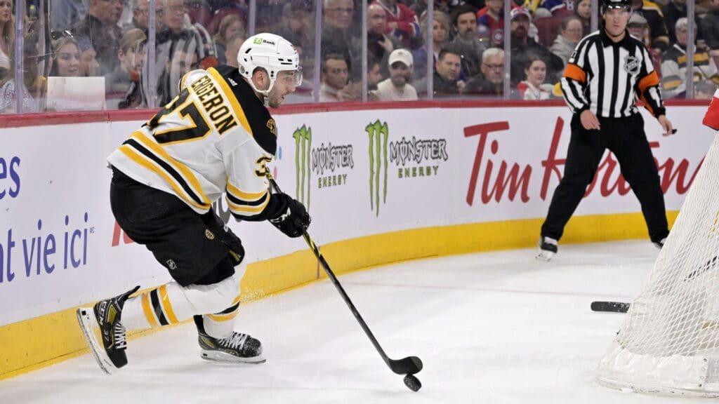 Apr 13, 2023; Montreal, Quebec, CAN; Boston Bruins forward Patrice Bergeron (37) plays the puck behind the Montreal Canadiens net during the first period at the Bell Centre.