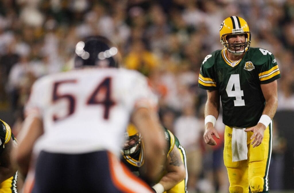 October 7, 2007; Green Bay, WI, USA; Green Bay Packers quarterback Brett Favre (4) calls a play as Chicago Bears linebacker Brian Urlacher (54) lines up before a play at Lambeau Field. The Bears defeated the Packers 27-20.