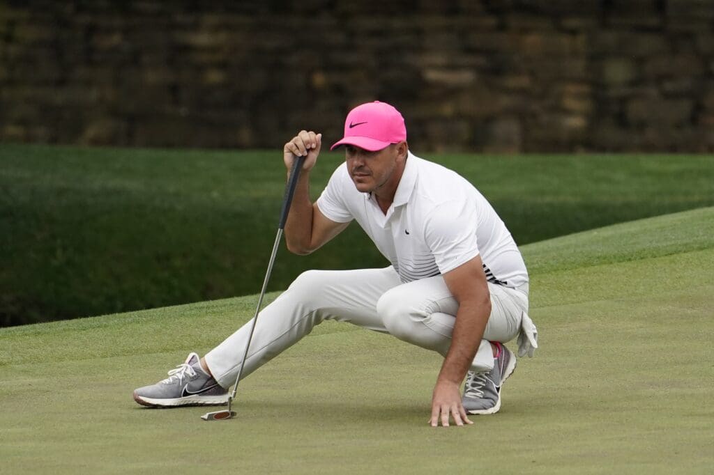 Apr 9, 2021; Augusta, Georgia, USA; Brooks Koepka lines up his putt on the 11th hole during the second round of The Masters golf tournament.