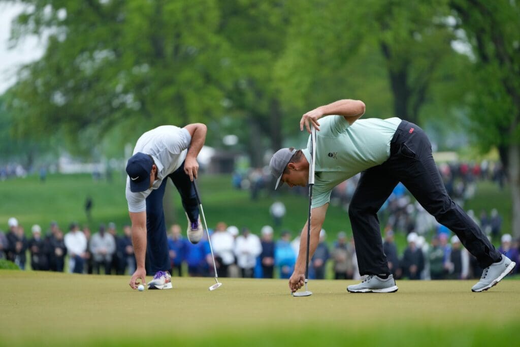 May 20, 2023; Rochester, New York, USA; Brooks Koepka and Bryson DeChambeau prepare to putt on the seventh green during the third round of the PGA Championship golf tournament.
