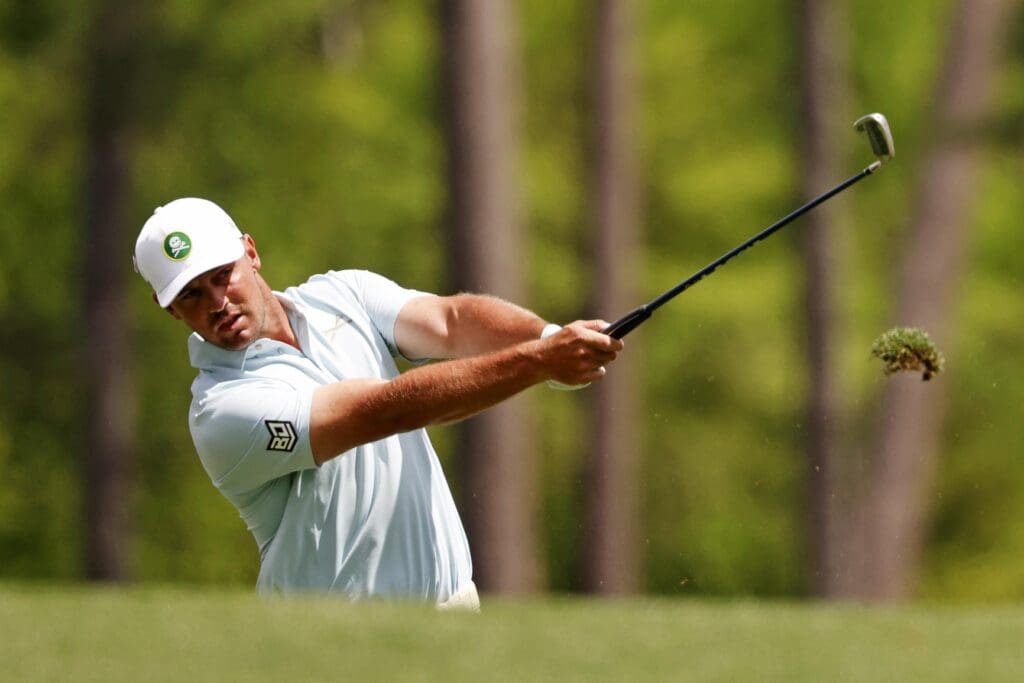 Apr 11, 2025; Augusta, Georgia, USA; Bryson DeChambeau plays from the fairway on the 12th green during the second round of the Masters Tournament at Augusta National Golf Club.