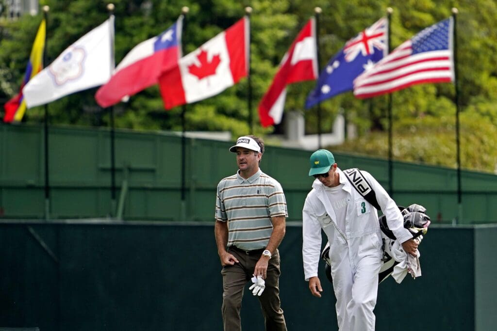 Apr 11, 2021; Augusta, Georgia, USA; Bubba Watson walks on the first hole with his caddie Ted Scott during the final round of The Masters golf tournament.