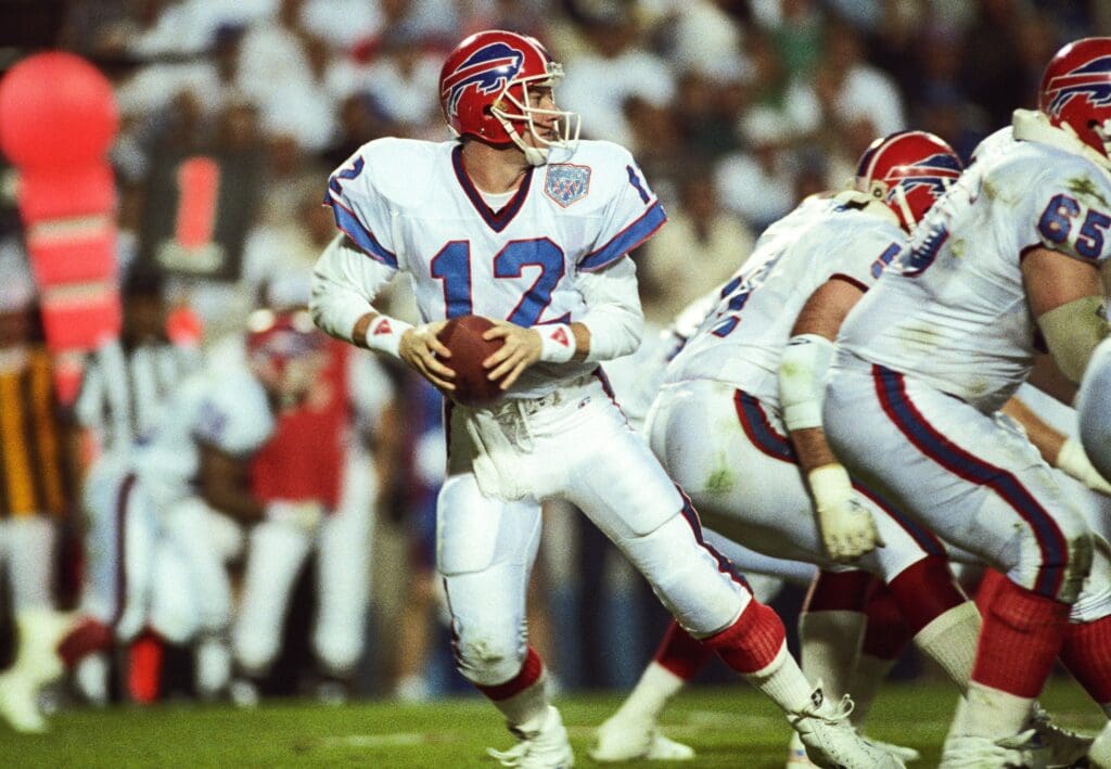 Jan 27, 1991; Tampa, FL, USA; FILE PHOTO; Buffalo Bills quarterback Jim Kelly (12) carries the ball against the New York Giants during Super Bowl XXV at Tampa Stadium. The Giants defeated the Bills 19-20.
