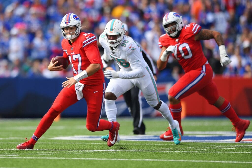 Oct 20, 2019; Orchard Park, NY, USA; Buffalo Bills quarterback Josh Allen (17) runs with the ball in front of Miami Dolphins defensive end Taco Charlton (96) during the first quarter at New Era Field.