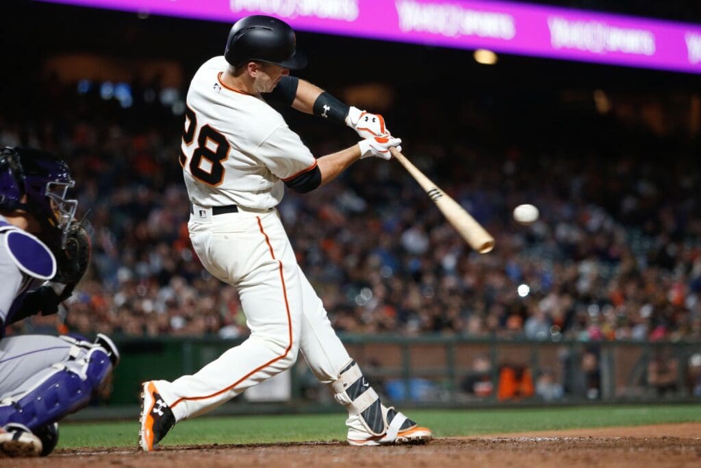 Jun 27, 2017; San Francisco, CA, USA; San Francisco Giants catcher Buster Posey (28) hits a single against the Colorado Rockies during the eighth inning of the game at AT&T Park.