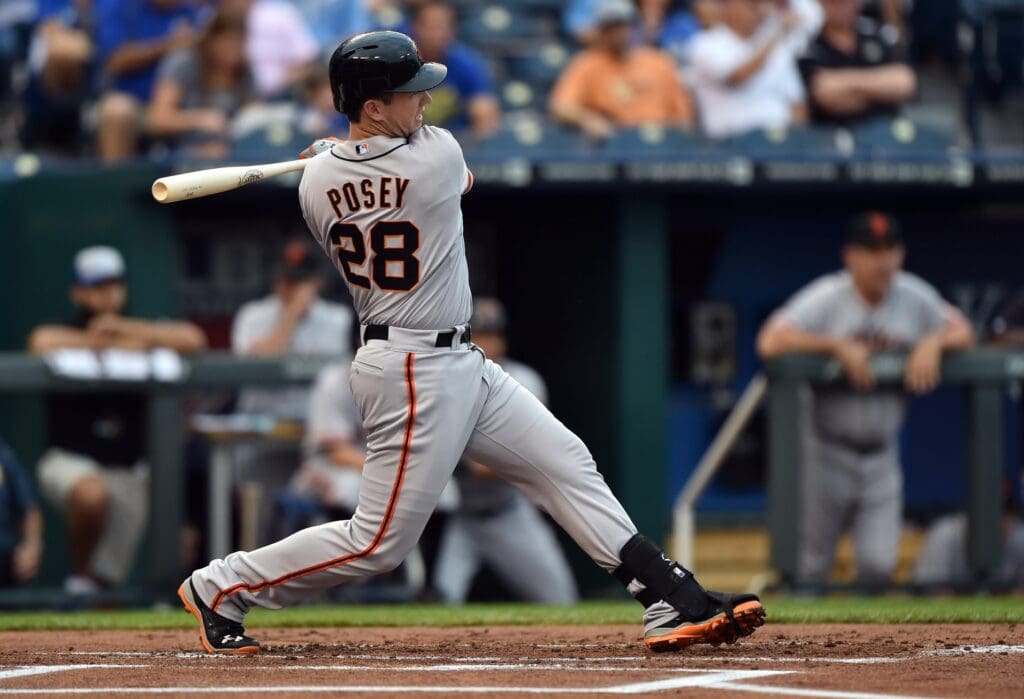 Aug 8, 2014; Kansas City, MO, USA; San Francisco Giants catcher Buster Posey (28) singles against the Kansas City Royals during the first inning at Kauffman Stadium