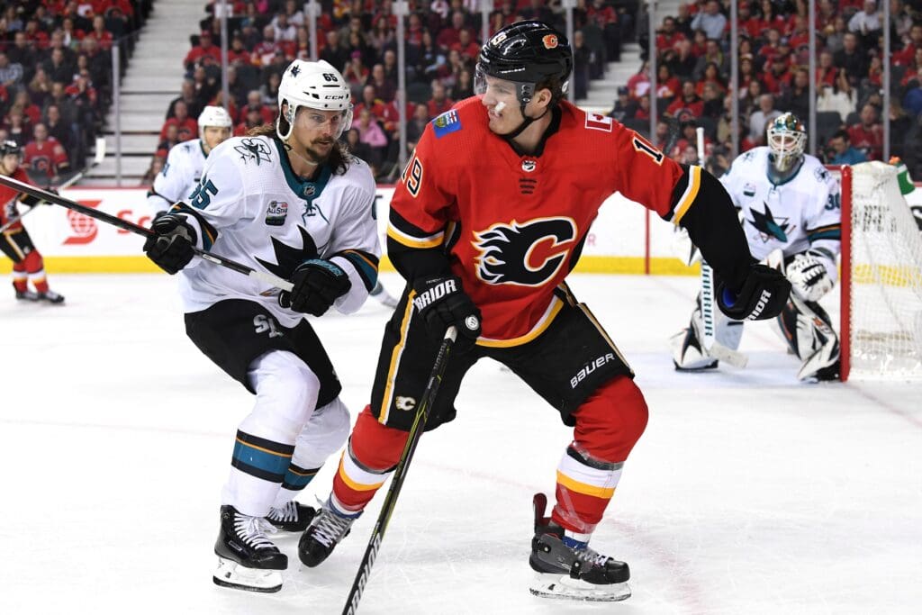 Dec 31, 2018; Calgary, Alberta, CAN; Calgary Flames left wing Matthew Tkachuk (19) skates against San Jose Sharks defenseman Erik Karlsson (65) during the this period at Scotiabank Saddledome. The Flames won 8-5.