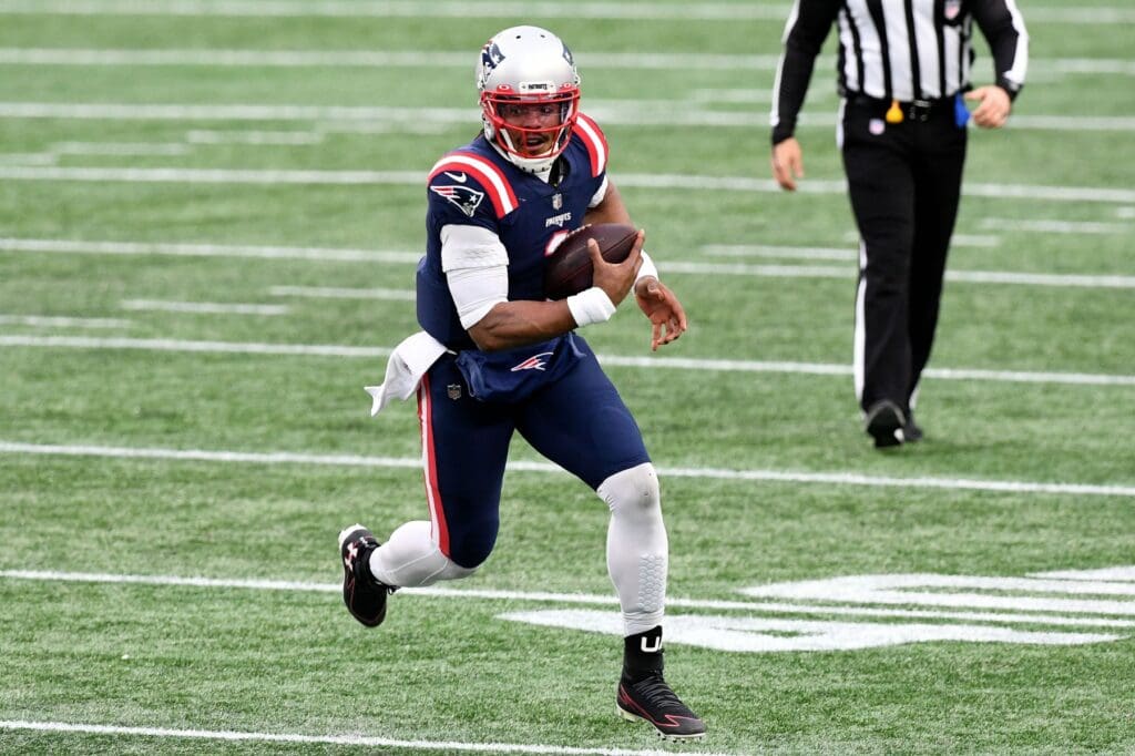 Jan 3, 2021; Foxborough, Massachusetts, USA; New England Patriots quarterback Cam Newton (1) runs with the ball during the second quarter of a game against the New York Jets at Gillette Stadium. 