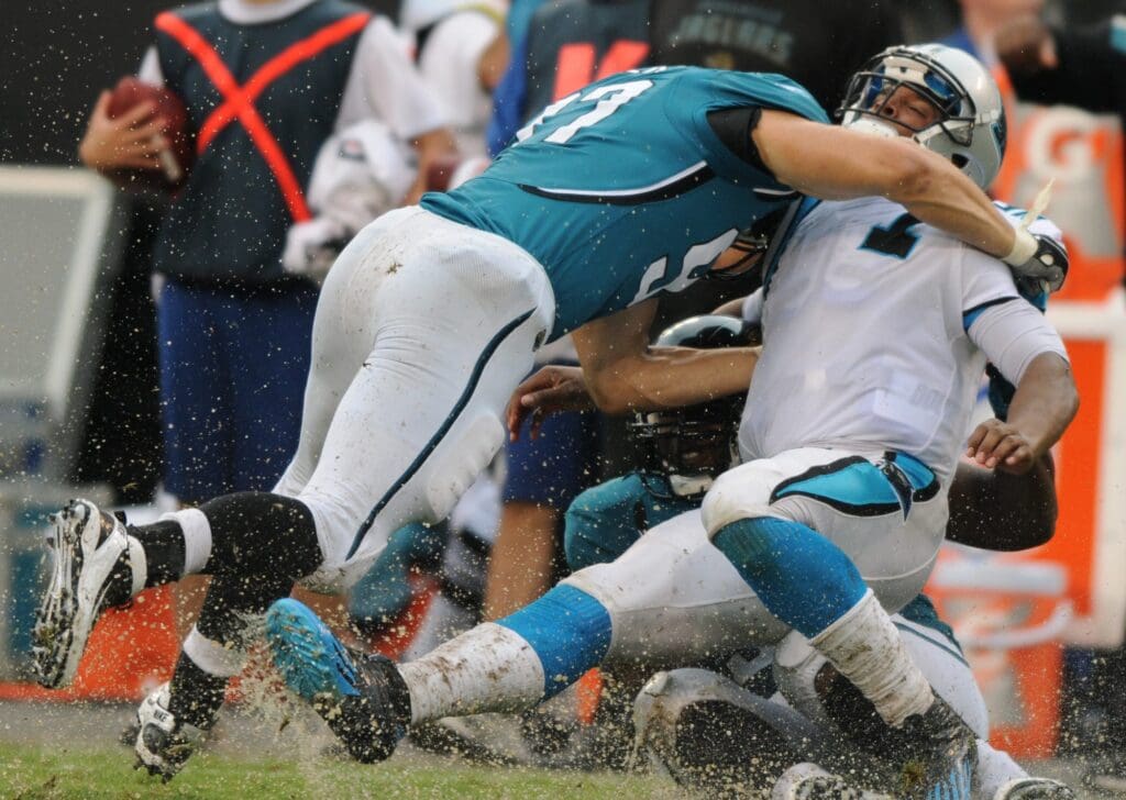 Carolina Panthers quarterback Cam Newton (1) is tackled by Jacksonville Jaguars lineman John Chick (97) after a scramble during an NFL football game in Charlotte, North Carolina on Sunday, September 25, 2011