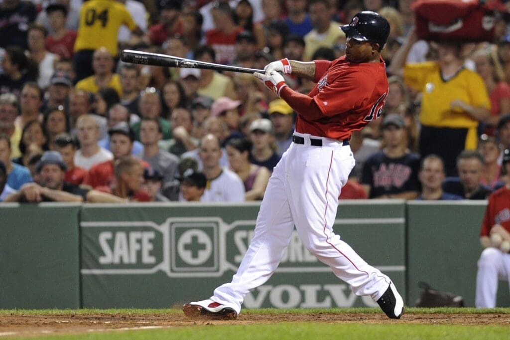 August 3, 2012; Boston, MA, USA; Boston Red Sox left fielder Carl Crawford (13) hits a three run home run during the third inning against the Minnesota Twins at Fenway Park.