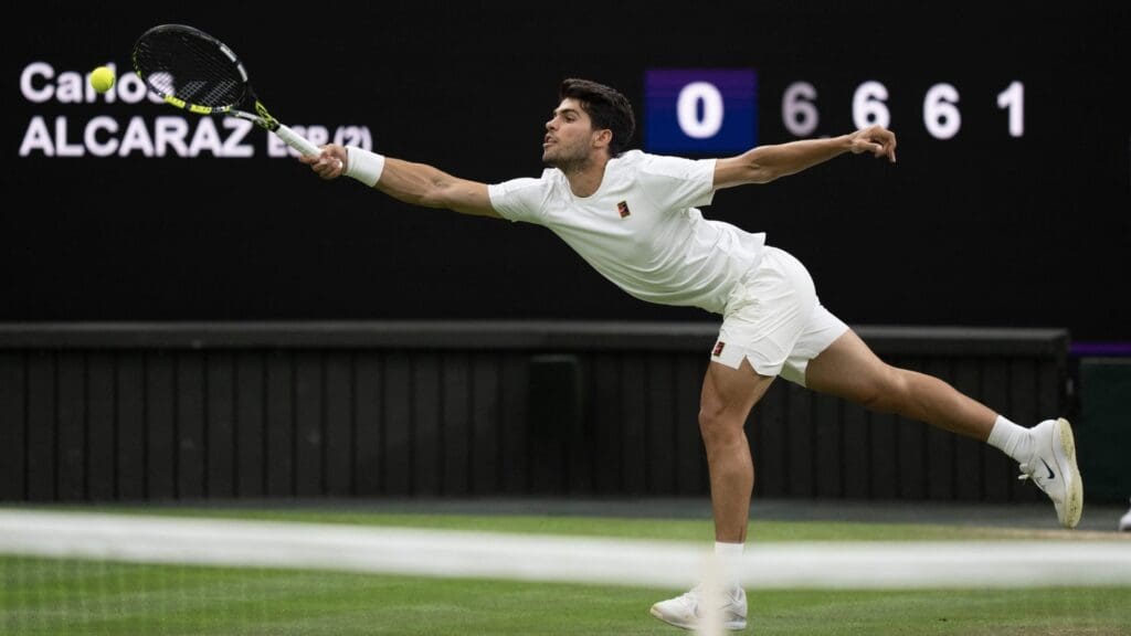 Jul 6, 2025; Wimbledon, United Kingdom; Carlos Alcaraz of Spain returns a shot during his match against Andrey Rublev on day seven at the All England Lawn Tennis and Croquet Club.