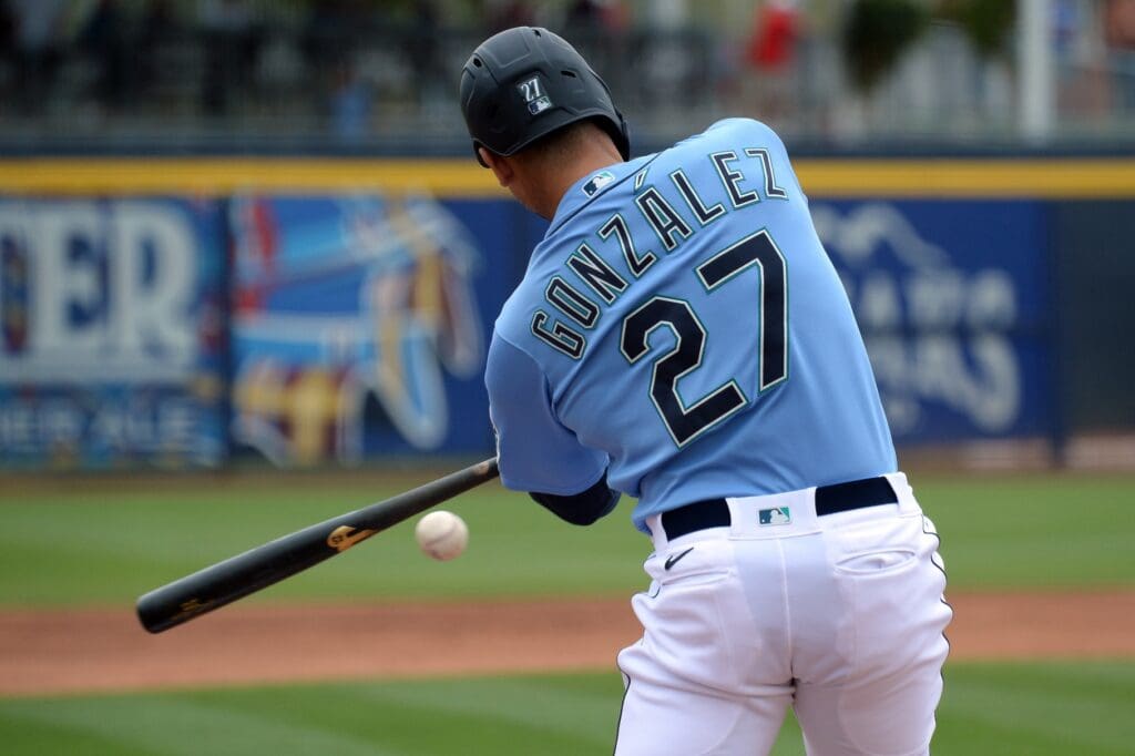Mar 10, 2020; Peoria, Arizona, USA; Seattle Mariners right fielder Carlos Gonzalez hits a single against the Los Angeles Angels during the second inning of a spring training game at Peoria Stadium. 