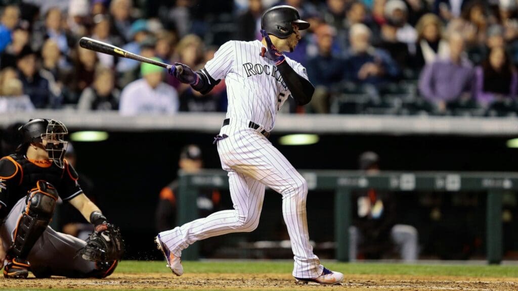Sep 26, 2017; Denver, CO, USA; Colorado Rockies right fielder Carlos Gonzalez (5) hits a double in the fifth inning against the Miami Marlins at Coors Field