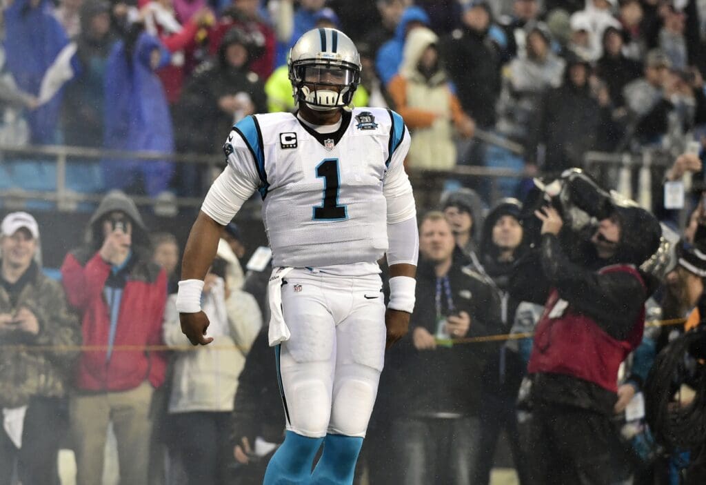 Jan 3, 2015; Charlotte, NC, USA; Carolina Panthers quarterback Cam Newton (1) runs onto the field before the 2014 NFC Wild Card playoff football game against the Arizona Cardinals at Bank of America Stadium.