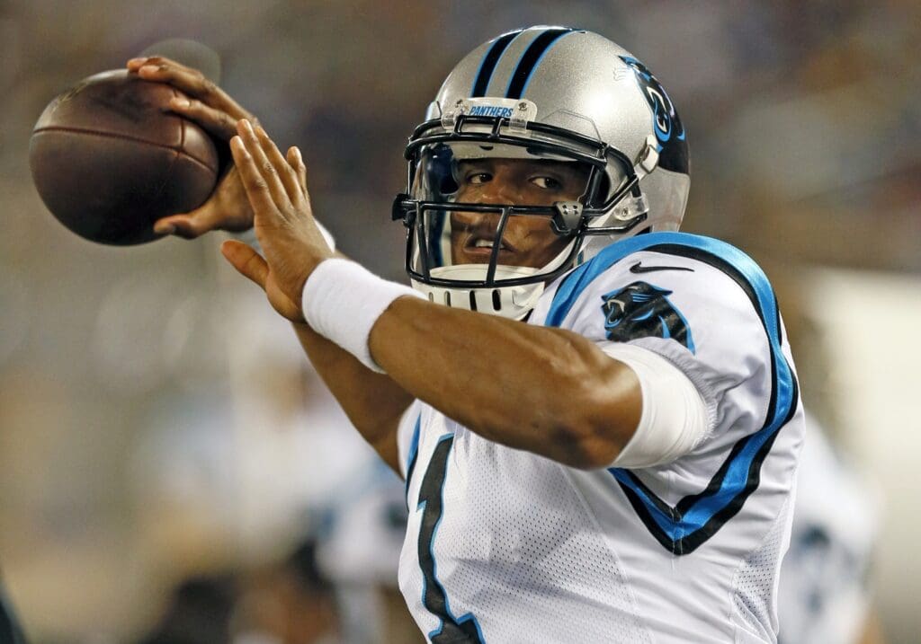 Aug 22, 2013; Baltimore, MD, USA; Carolina Panthers quarterback Cam Newton (1) warms up on the sidelines between plays against the Baltimore Ravens at M&T Bank Stadium.
