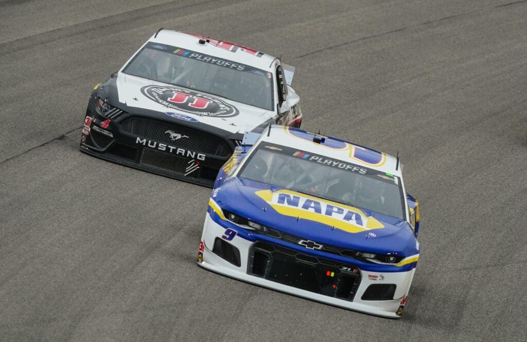 Oct 18, 2020; Kansas City, Kansas, USA; NASCAR Cup Series driver Chase Elliott (9) leads Kevin Harvick (4) during the Hollywood Casino 400 at Kansas Speedway.
