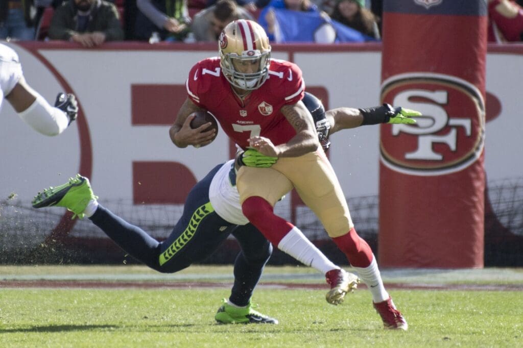 January 1, 2017; Santa Clara, CA, USA; San Francisco 49ers quarterback Colin Kaepernick (7) runs past Seattle Seahawks outside linebacker K.J. Wright (50) during the first quarter at Levi's Stadium.