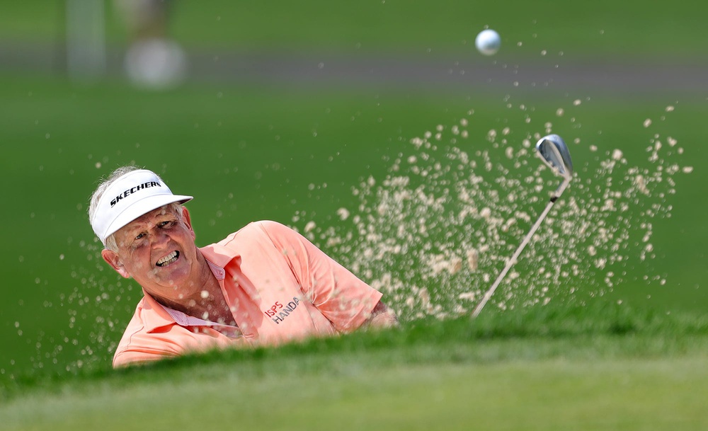 Colin Montgomerie watches his shot out of the bunker on the 13th hole during second round of the Bridgestone Senior Players Tournament at Firestone Country Club on Friday. Bridgestonejl 19
